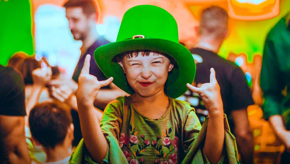 Foto mostra um menino com o tradicional chapéu de Saint Patrick